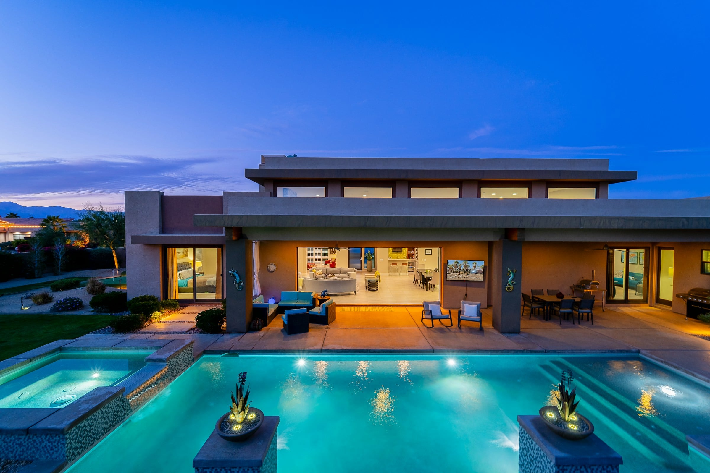 A modern villa and pool at dusk
