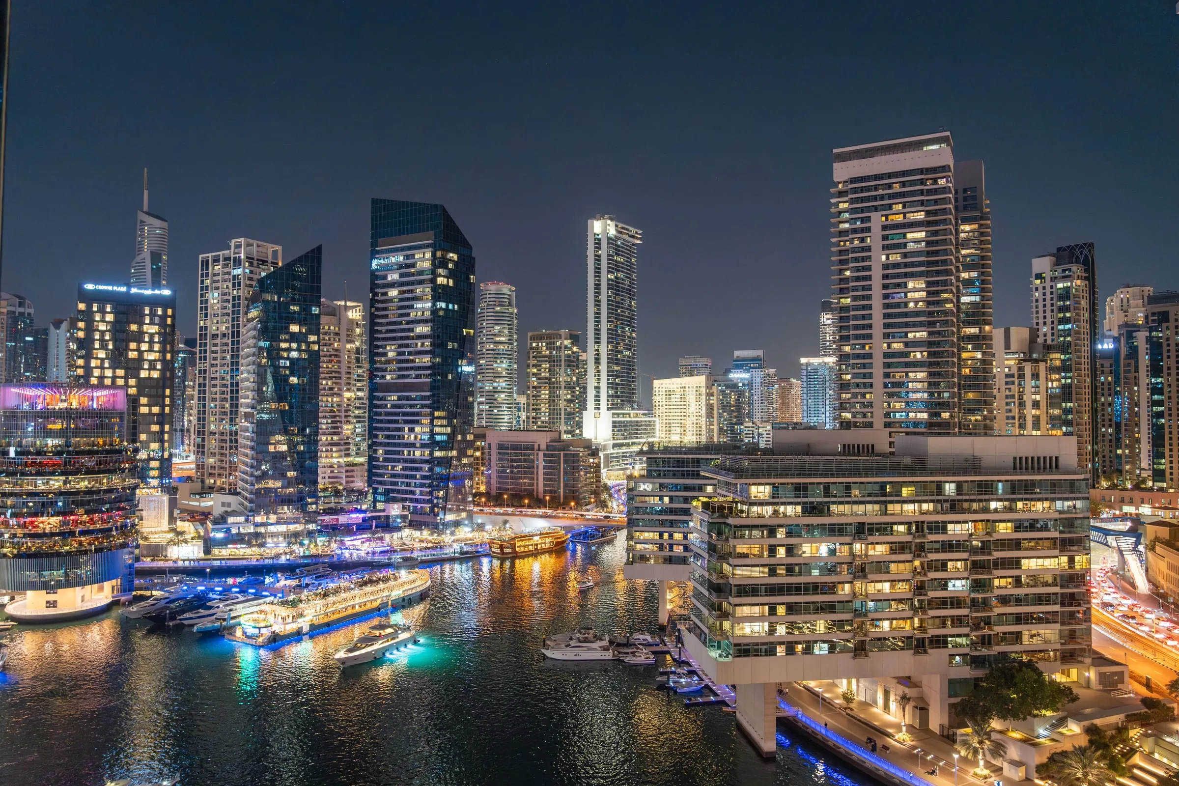 Dubai Marina towers and yachts at dusk